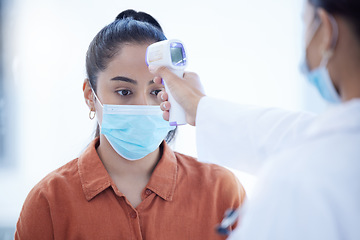 Image showing Covid, young woman and thermometer scan device nervous, anxious or scared for test results. Female, girl and lady with mask being check for corona temperature, high fever or illness by medical doctor