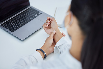 Image showing Business woman with a wrist injury, pain or accident from typing or stress sitting by a desk in her office. Girl with muscle sprain, inflammation or carpal tunnel with medical emergency at workplace.