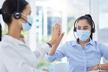 Image showing Covid, high five and women in call center with face mask for office compliance, target success or goal achievement. Sales, telemarketing or e commerce business people hands teamwork, support and care