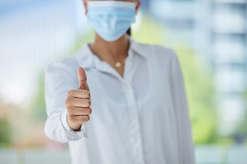 Image showing Thumbs up, success and woman with covid at work in an office. Corporate employee, manager or worker in support, agreement and happy with business working at a startup marketing company with face mask