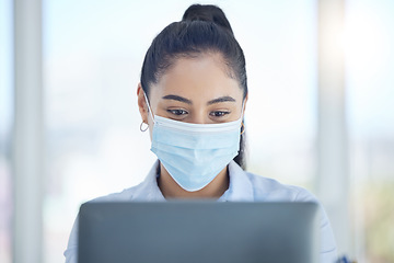 Image showing Covid, business and woman reading on laptop while working in an office at work. Corporate employee with email on computer, typing proposal and doing search on the internet with face mask at a company