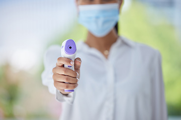 Image showing Covid, hand and health thermometer in office, healthcare or wellness check from a employee. Woman work with medical equipment to document fever for disease, dengue fever or corona scan at a workplace