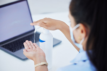 Image showing Covid, hand sanitizer and a woman with laptop and face mask in office. Online work, hygiene and a businesswoman with alcohol spray on hands at desk. Safety, working and cleaning hands during pandemic