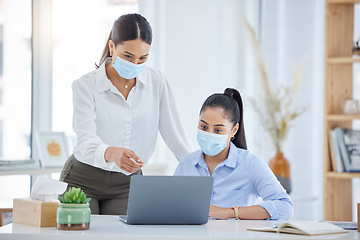 Image showing Covid, training and employees talking with laptop in an office together at work. Corporate workers speaking about strategy for business, reading email and working on a proposal on a pc with face mask
