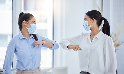 Image showing Business team, elbow bump and covid safety with employees greeting doing social distance in an office. Manager and woman in office during coronavirus with a face mask and working after lockdown