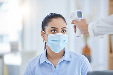 Image showing Woman, covid 19 and thermometer for safety, health and sign of infection. Doctor, patient and technology in face with mask for wellness, protection and stop of coronavirus sickness in Los Angeles