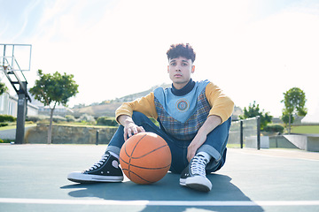 Image showing Man, basketball and training sitting on basketball court for rest, relax or breathe during practice. Basketball player, workout and sports for game in park for sport, fitness and physical health