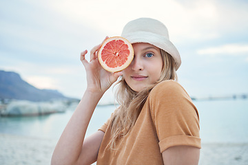 Image showing Grapefruit, wellness and woman on tropical beach for nature holiday, vacation or outdoor vitamin c health. Vegan, youth lifestyle for skin care, detox or healthy eating with sky mockup and sea water