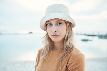 Image showing Hipster woman, holiday at the beach and portrait of calm or relaxing Norway coastal getaway trip. Peaceful summer vacation, seaside sand and young person enjoying time alone at the Oslo ocean harbor