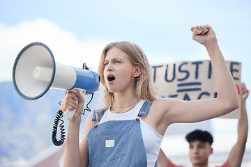 Image showing Justice, megaphone and woman protest for justice, community solidarity and human rights voice on racism, government and women equality. Activism crowd or people with cardboard sign and freedom speech