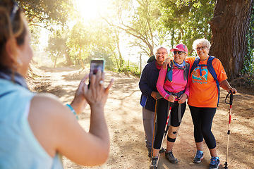Image showing Phone, photograph senior women hiking group in forest on summer holiday weekend. Nature, elderly female friends and walk on adventure trail. Friendship, fun and fitness on retirement hike in forest.