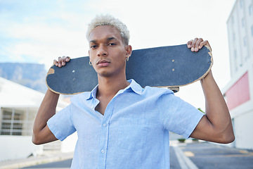 Image showing Black man, serious with a skateboard and city, urban background and trendy, hipster fashion in portrait. Young African American hobbies, skater and gen z youth outdoors at skatepark during summer.