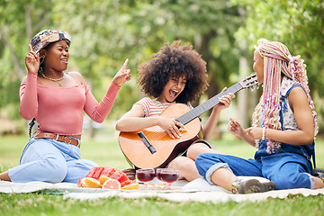 Image showing Black women, friends and picnic in park with guitar playing music, singing and spending time together. Comic, funny and happy ladies with acoustic string instrument, food or wine outdoors for lunch.