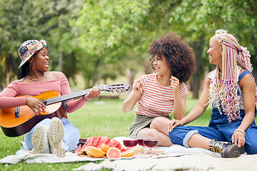 Image showing Music, comic and friends on picnic in a park with food and singing with a guitar together in summer. Funny, playful and African women with smile for musician, instrument and lunch on grass in nature