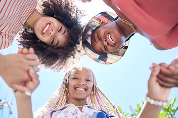 Image showing Girl, friends and circle below holding hands together for solidarity, trust and happiness. Black woman, group and huddle with smile, unity and face look on face together for fun, vacation or holiday