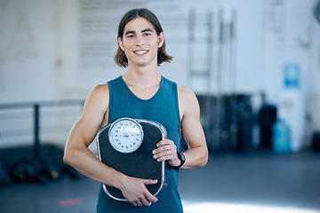 Image showing Fitness, exercise and weight scale with a sports man in the gym for training, workout or weightloss. Health, wellness and motivation with a male athlete in a club for exercising or staying active