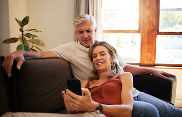 Image showing Elderly, couple and phone together on sofa for social media, video or blog on internet with smile on face. Senior, man and woman with smartphone in living room for communication, relax or meme on app