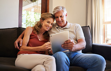 Image showing Tablet, movie and senior couple streaming a film on the internet from the living room sofa of their house. Happy elderly man and woman on a subscription service website for a film with tech on couch