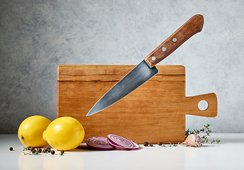 Image showing wooden cutting board and levitating knife