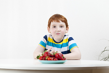 Image showing handsome boy with strawberries