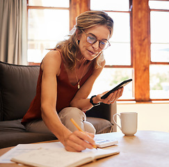 Image showing Senior woman, phone and writing calculation in book on sofa, web search or investment planning. Retirement, elderly female and 5g mobile, internet banking or budget and savings with coffee in house.