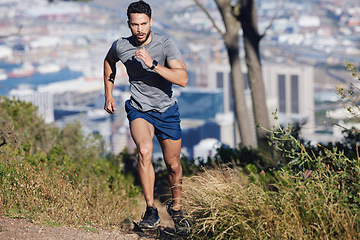 Image showing Man is running, fitness and exercise workout for cardio, health and wellness journey in nature outdoors. Young runner, determined and motivation for sports training and healthy lifestyle.