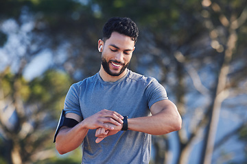 Image showing Runner with fitness smart watch, app and check running time for health tracking tech on nature run. Sports athlete doing workout practice for cardio wellness, physical fitness and marathon training