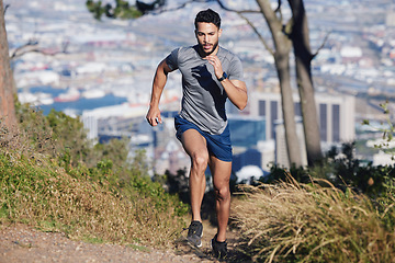 Image showing City, runner and man running in nature training, cardio exercise and endurance workout for a marathon. Sports, fitness and healthy athlete on jog on a forest or mountain trail outdoors in summer