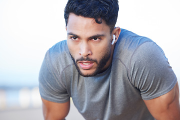 Image showing Man tired during fitness workout, breathing and running exercise routine for health and wellness. Earphone, endurance, and cardio training, young person working out and take a break.