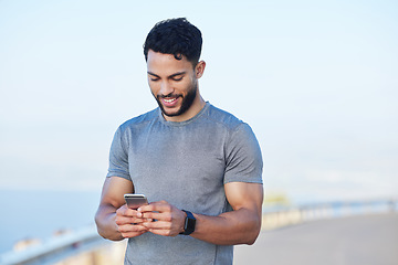 Image showing Phone, fitness and app with a sports man tracking his progress online with 5g mobile technology. Exercise, training and workout with a male athlete posting his personal performance to social media