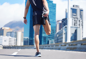 Image showing Man, stretching legs and back view in city, street or urban road outdoors. Fitness, health and male athlete stretch or warm up before exercise, running or training outside for marathon run in town.