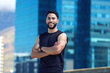 Image showing Fitness, exercise and city with a sports man outside for health, wellness or a running workout. Training, sport and healthy with a male athlete standing arms crossed in an urban town alone