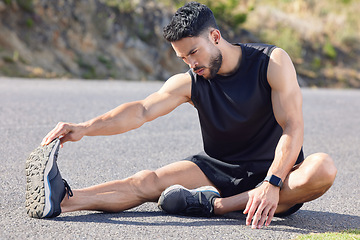 Image showing Fitness, exercise and stretching with a sports man preparing for a workout or cardio training on a road in nature. Health, wellness and performance with a male athlete at the start of a routine