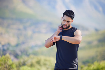 Image showing Man on run check pulse, heart rate and body stats for health with smartwatch on nature run. Runner does outdoor exercise for fitness, sports workout and cardio training to increase race running time