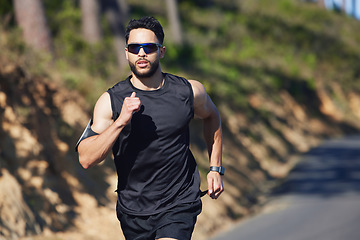 Image showing Running, man and outdoor cardio fitness in nature for wellness, marathon training and healthy lifestyle in Dubai, UAE. Sports athlete, speed runner and morning exercise with sunglasses on summer road