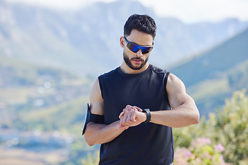 Image showing Sports man time smartwatch in outdoor fitness, training exercise time for mountain marathon and tracking heartbeat. Digital stopwatch for workout, monitor performance with technology and runner rest