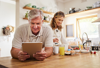 Image showing Cooking, tablet and food with old couple in kitchen in the morning for breakfast, health and internet recipe together. Happy, digital and retirement with senior man and woman baking for diet at home