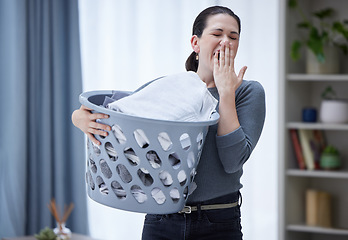 Image showing Tired, yawning and woman with laundry basket in home feeling stress, burnout and fatigue from spring cleaning, washing clothes and chores. Exhausted sleepy female covering mouth from bored housework