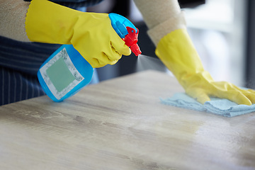Image showing Hands, gloves and spray cleaning table with disinfectant for clean house. Kitchen counter, home safety and disinfection with alcohol solution in bottle to protect home from germs, dust and bacteria.