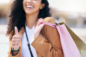 Image showing Happy, shopping and a thumbs up, woman with a smile and fashion sale bag in the city. Success, winner discount sales and retail therapy, a lady from Brazil smiling with shopping bag and happiness.