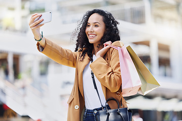 Image showing Fashion, shopping and woman taking a selfie in the city standing in the street. Black woman with shopping bags, phone in hand and taking a picture in retail shopping mall, happy from sale or discount