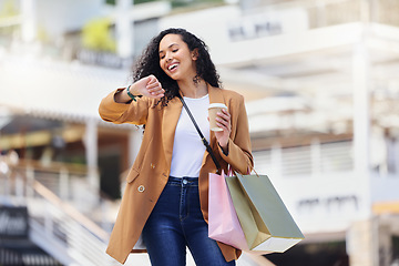 Image showing Time, shopping and woman with notification on watch with coffee in the city of Los Angeles. Happy, smile and girl walking with smart technology for fashion deal and retail bag in the mall after sale