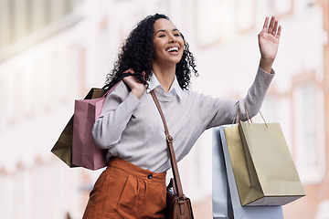 Image showing Shopping, travel and woman try to stop taxi for transport in urban city after shopping spree of fashion, sales or discount clothes. Retail, bag and young black customer with hand gesture for cab ride