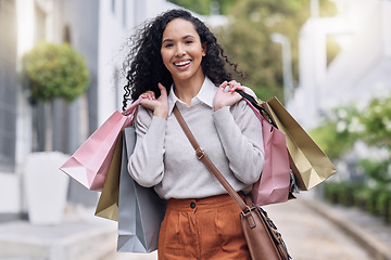 Image showing Shopping, retail and city with a black woman customer on the search for a sale, bargain or deal. Money, consumer and shopper with young female at an outdoor store or mall for buying and spending