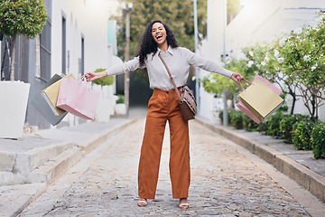 Image showing Woman customer, in street and with shopping bags celebrate sale from store, shopping and happy with purchase. Female consumer, confident client and excited outdoor, discount items and retail therapy.