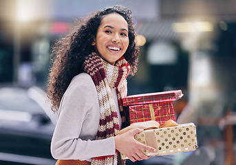 Image showing Christmas gift shopping, customer and city girl buy sales, discount or retail product for festive season. Happiness, presents and smile from happy black woman on shopping spree travel in urban town