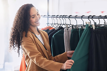 Image showing Retail, happy and woman with choice while shopping in a fashion boutique during a sale on clothes. Young black woman and customer withh smile in a store or shop for designer clothing on discount