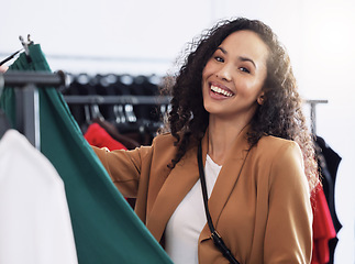 Image showing Woman customer, in clothes shop and happy browse, look through clothing racks and smile. Consumer, fashion and female client shopping in store for items, being relax or in boutique for retail therapy