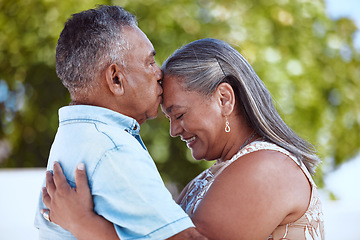 Image showing Elderly, couple and happy with love, hug and kiss on face in backyard, garden or park together in summer. Man, woman and retirement show romance, bonding and care in nature, smile and embrace