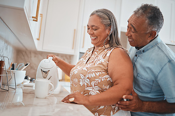 Image showing Tea, couple and retirement with a man and woman using a kettle in the kitchen of their home together. Love, morning and romance with a senior male and woman making a coffee beverage in their house